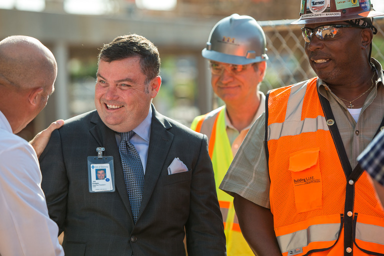 Candid construction site portrait with workers and executive