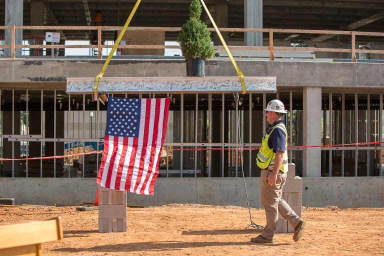 The tree-topping ceremony with flag at St. Anthony Hospital's new construction site building PCP_Sts_4207