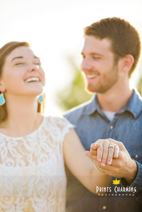 portrait of laughing happy engaged couple showing engagement ring PCP_TrLa_5654